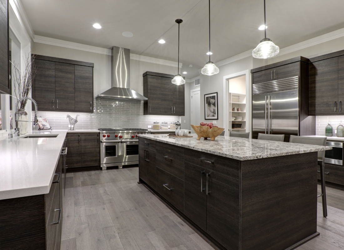 Pendant lighting installation over a kitchen island by SD Build Co